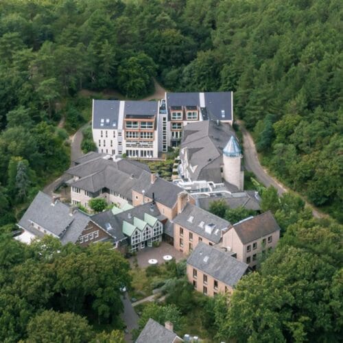 Blooming hotel seen from the air, set among the woods outside Bergen