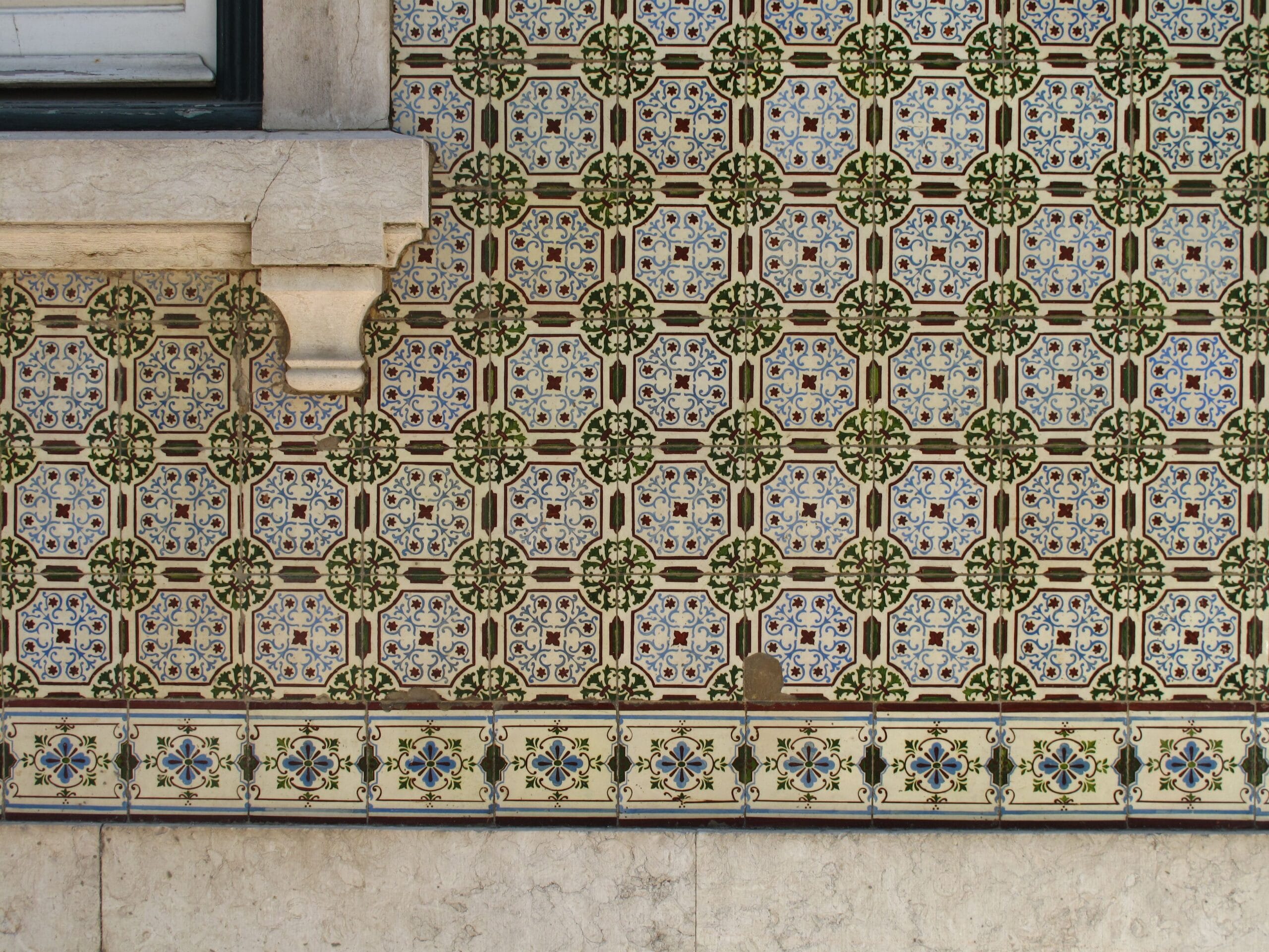 Traditional patterned azulejo tiles covering a wall in Lisbon