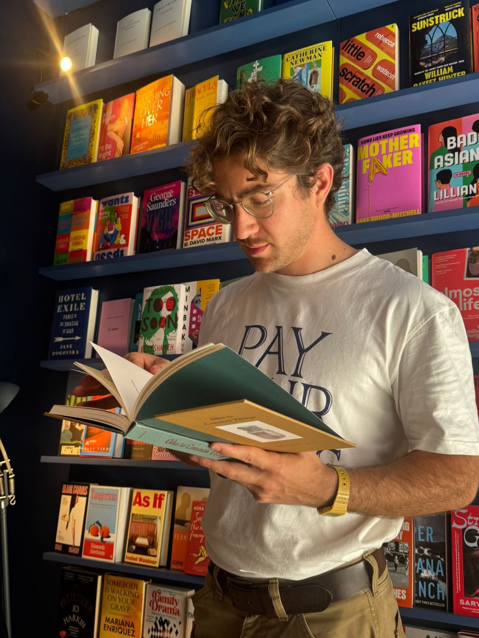 Giacomo Boffi, poet and founder of Home of Poetry, reading a book in a Lisbon bookshop