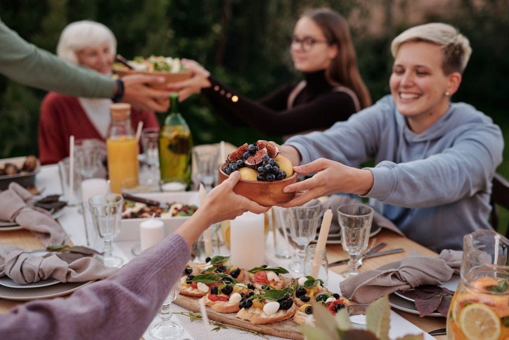 Guests sharing a long lunch table at a knitting retreat in Portugal